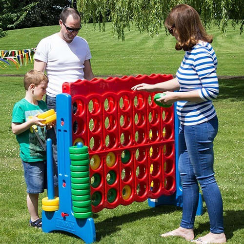 Family playing giant Connect Four game