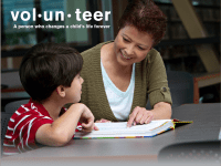 Woman helping child read