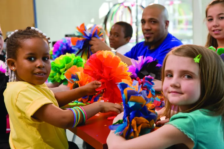 Kids in after school program doing a craft.