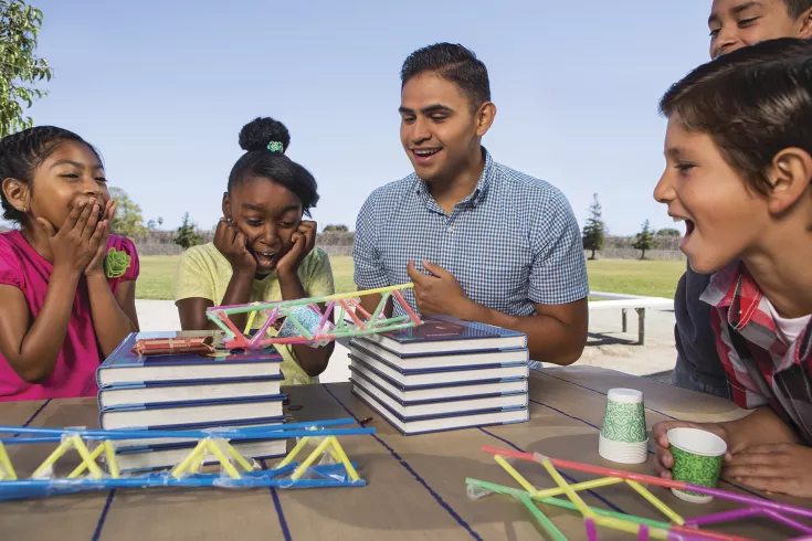 Kids cheering as they watch a science demo