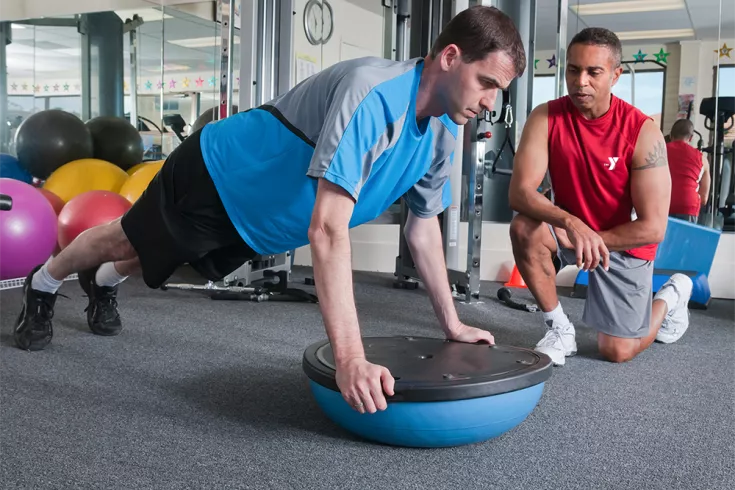 Man exercising with a Y Personal Trainer