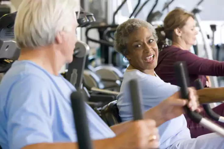 Older adults exercising on equipment