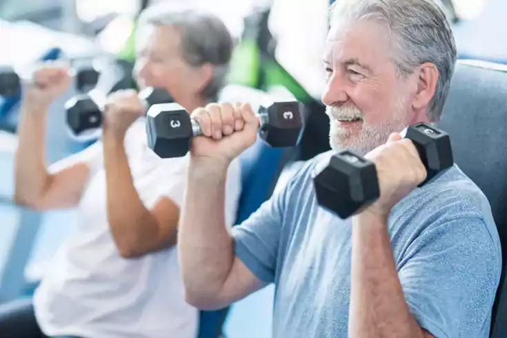 Senior adults lifting weights