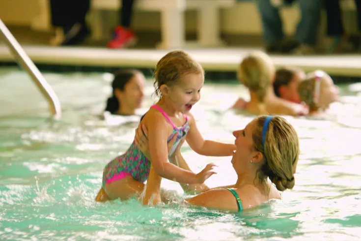 A mother and daughter playing in the pool