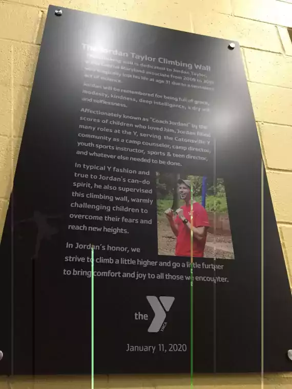 plaque displayed on the climbing wall at the Y in Catonsville honoring Jordan Taylor