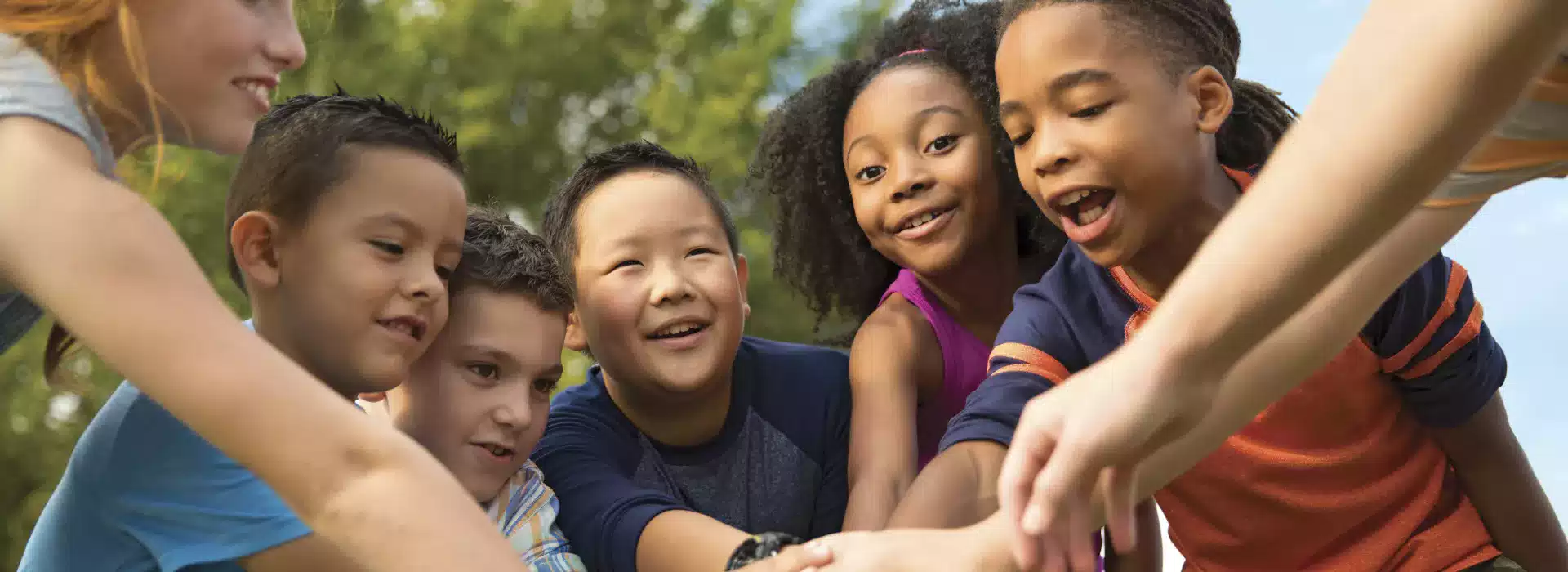 Diverse kids doing a team cheer