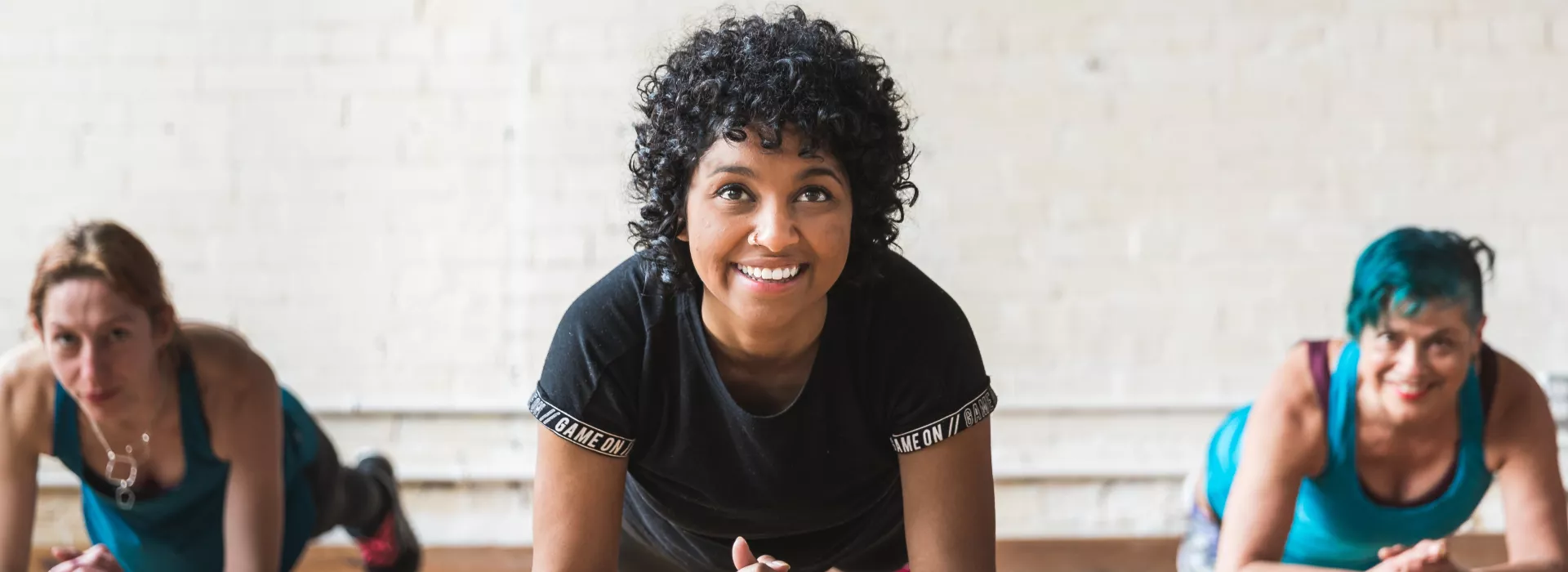 Three women doing plank exercises