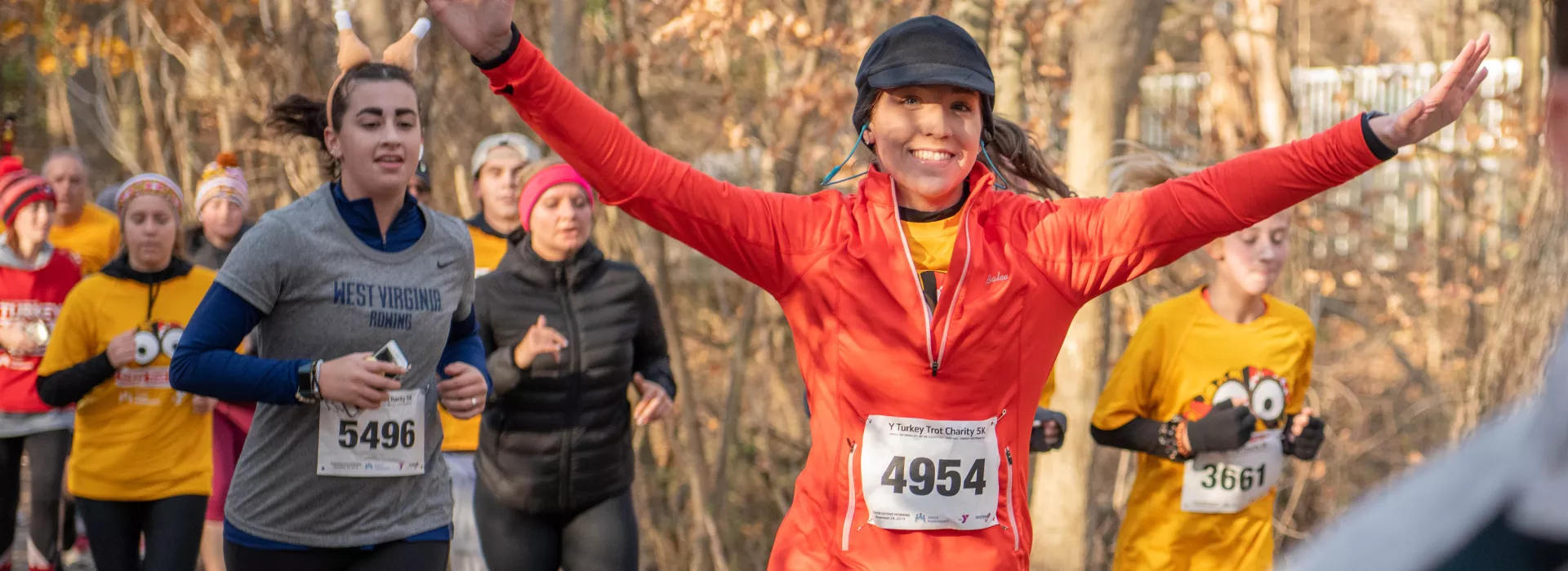 Woman running with arms up in victory