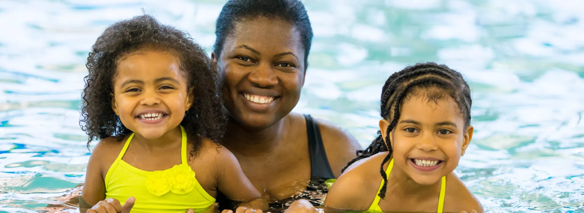 Mom and daughters in pool
