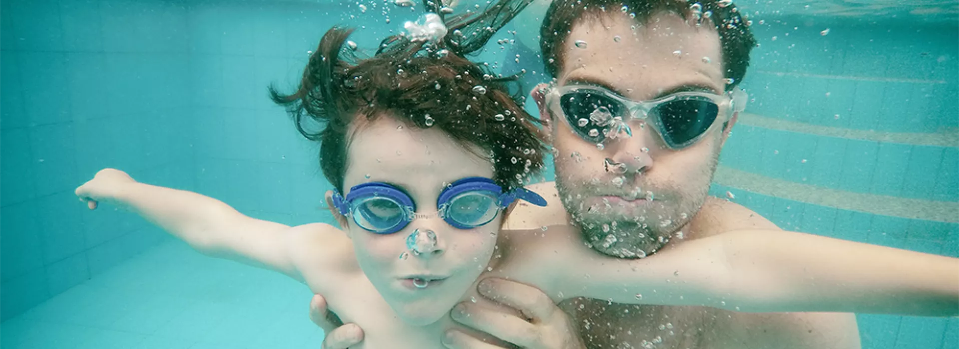 Father and son in pool