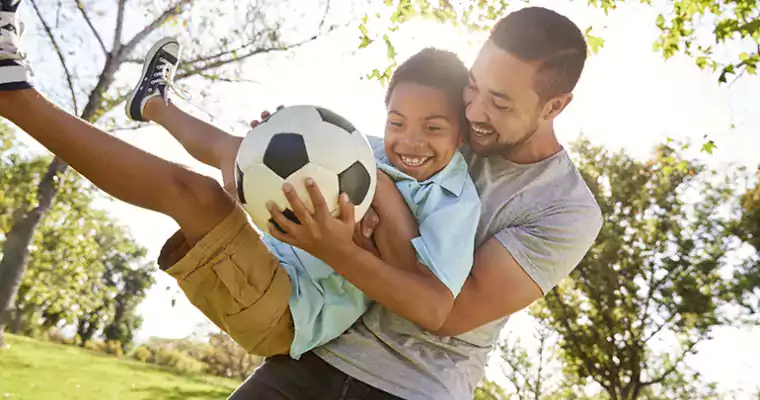 Dad and son with soccer ball